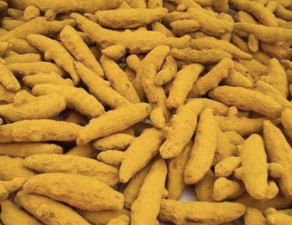 Bright yellow turmeric powder and roots.